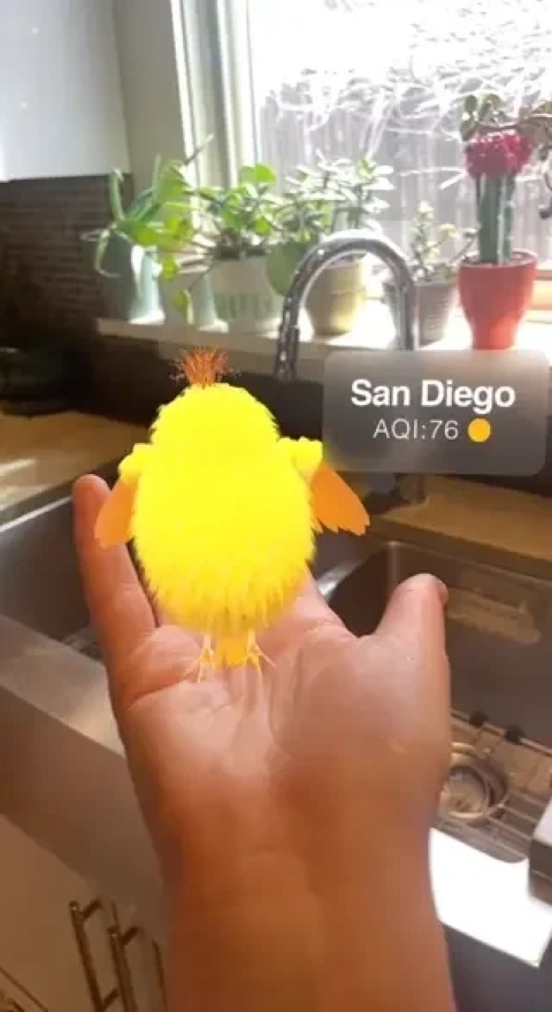 A small yellow digital bird on a hand, showing San Diego air quality