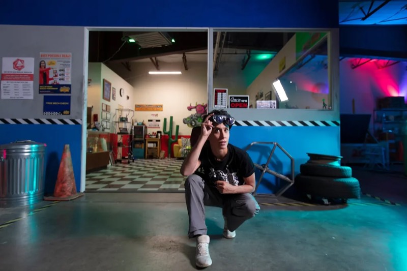 A person crouching in the entrance of the garage set