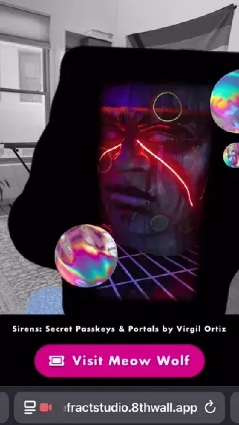 A phone showing an AR portal into a room with a glowing red face